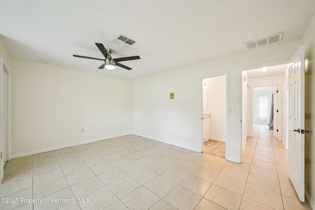 18633 Oak Way Dr, Hudson, FL 34667 - unfurnished bedroom featuring light tile patterned floors, a ceiling fan, and baseboards