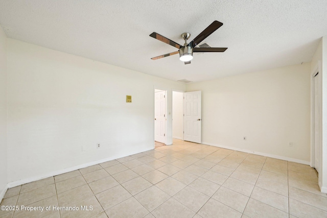 18633 Oak Way Dr, Hudson, FL 34667 - empty room featuring ceiling fan, light tile patterned floors, a textured ceiling, and baseboards