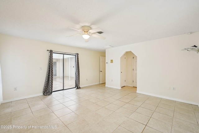 18633 Oak Way Dr, Hudson, FL 34667 - unfurnished room featuring ceiling fan, light tile patterned floors, arched walkways, and baseboards
