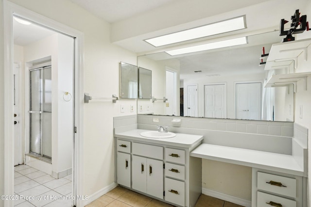 18633 Oak Way Dr, Hudson, FL 34667 - bathroom featuring vanity, a stall shower, tile patterned flooring, and tasteful backsplash