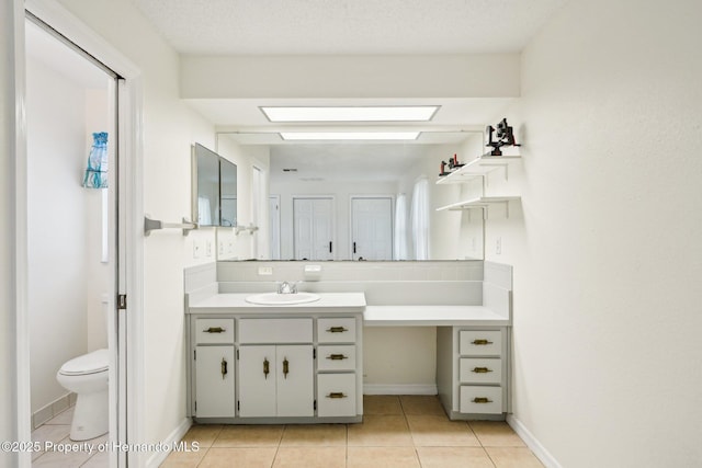 18633 Oak Way Dr, Hudson, FL 34667 - bathroom featuring vanity, tile patterned floors, toilet, a skylight, and baseboards