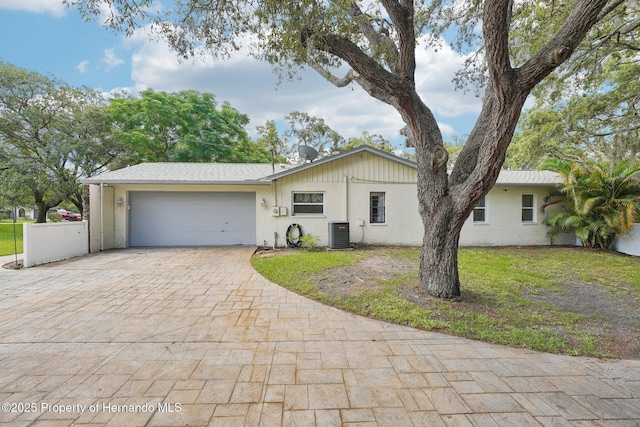 18633 Oak Way Dr, Hudson, FL 34667 - single story home featuring cooling unit, a garage, decorative driveway, stucco siding, and a front yard