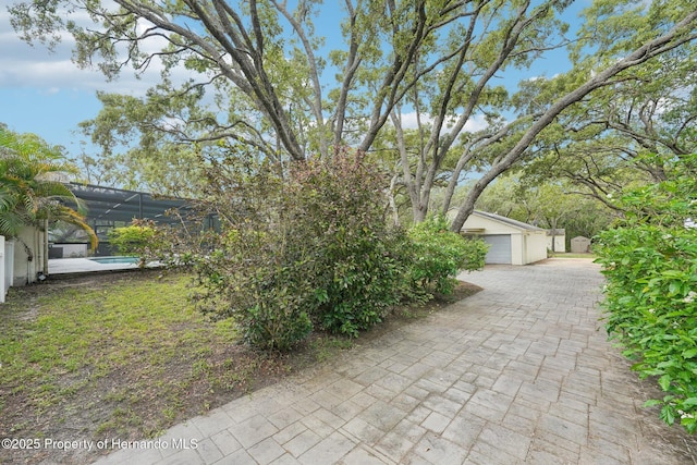 18633 Oak Way Dr, Hudson, FL 34667 - view of patio / terrace featuring a garage, an outbuilding, glass enclosure, and a pool