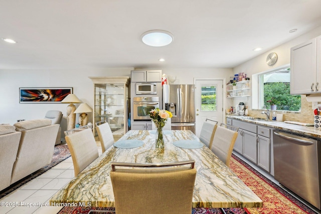 18633 Oak Way Dr, Hudson, FL 34667 - dining area with light tile patterned floors and recessed lighting
