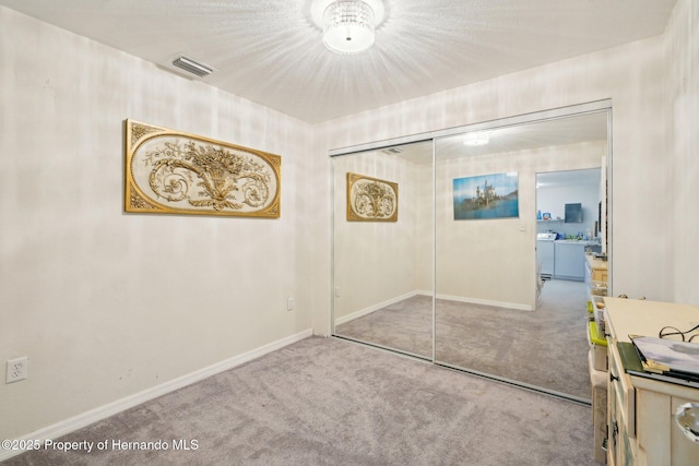 18633 Oak Way Dr, Hudson, FL 34667 - unfurnished bedroom with washing machine and clothes dryer, carpet, and baseboards
