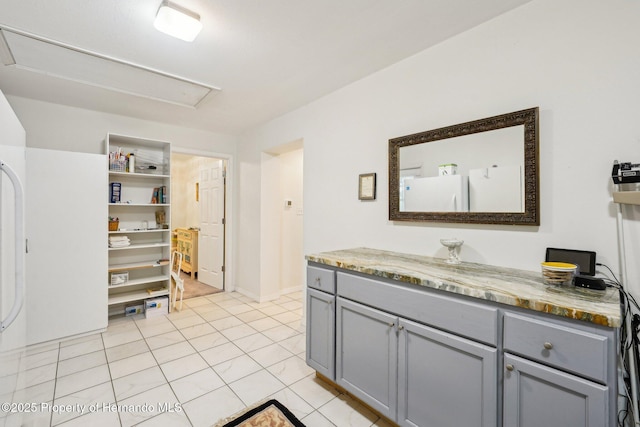18633 Oak Way Dr, Hudson, FL 34667 - kitchen featuring gray cabinets, light stone countertops, light tile patterned floors, and open shelves