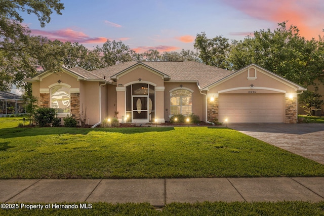 10296 Palmgren Ln, Spring Hill, FL 34608 - view of front of home with stone siding and stucco siding