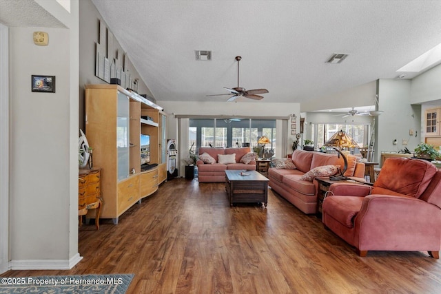 10267 Elgin Blvd, Spring Hill, FL 34608 - living room with a textured ceiling, ceiling fan, wood finished floors, plenty of natural light, and vaulted ceiling