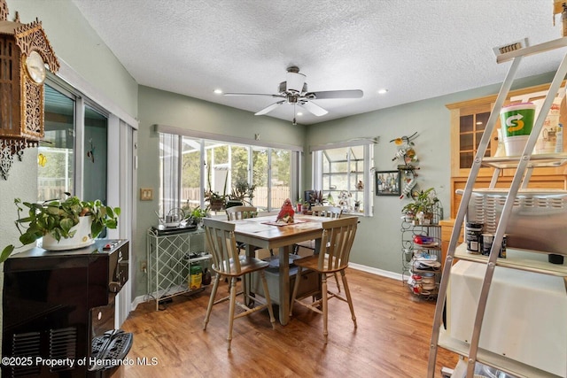 10267 Elgin Blvd, Spring Hill, FL 34608 - dining room featuring baseboards, ceiling fan, a textured ceiling, wood finished floors, and recessed lighting
