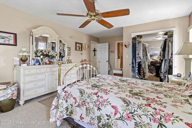 10267 Elgin Blvd, Spring Hill, FL 34608 - bedroom featuring a walk in closet, light colored carpet, a closet, and a ceiling fan