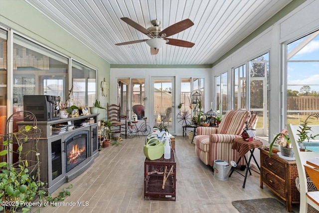 10267 Elgin Blvd, Spring Hill, FL 34608 - sunroom with a ceiling fan, healthy amount of natural light, wooden ceiling, and an outdoor living space with a fireplace