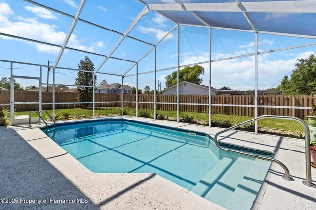 10267 Elgin Blvd, Spring Hill, FL 34608 - view of swimming pool featuring a fenced backyard, a patio, and glass enclosure