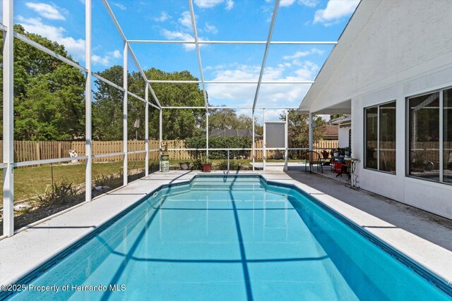 10267 Elgin Blvd, Spring Hill, FL 34608 - view of swimming pool featuring a fenced backyard, a patio, and glass enclosure