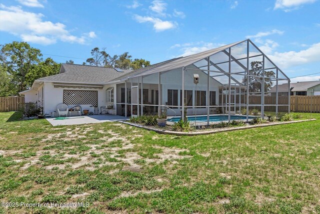 10267 Elgin Blvd, Spring Hill, FL 34608 - rear view of property with a patio area, glass enclosure, and roof with shingles