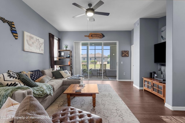 9407 Burnam Dr, Weeki Wachee, FL 34613 - living room featuring ceiling fan, dark wood-type flooring, and baseboards