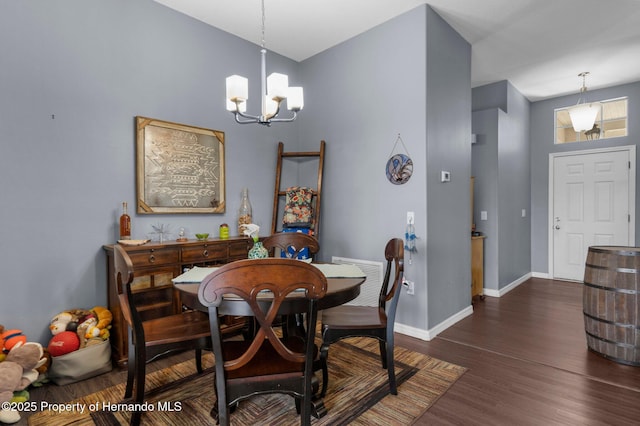 9407 Burnam Dr, Weeki Wachee, FL 34613 - dining space with a chandelier, baseboards, and dark wood-type flooring