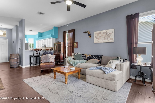 9407 Burnam Dr, Weeki Wachee, FL 34613 - living area featuring wood finished floors, a ceiling fan, and baseboards