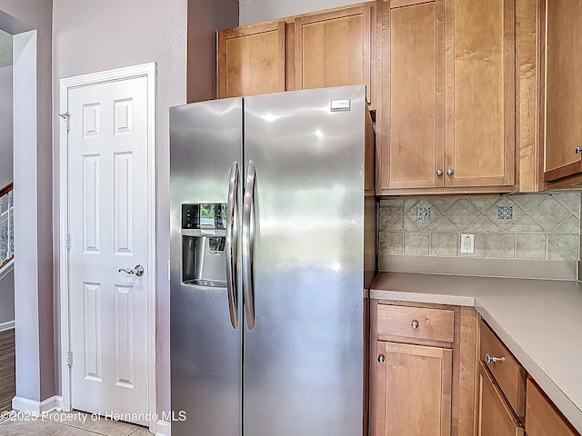 14137 Wake Robin Dr, Brooksville, FL 34604 - kitchen featuring stainless steel fridge, tasteful backsplash, light countertops, and brown cabinetry