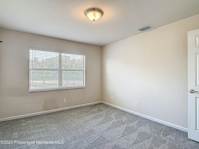 14137 Wake Robin Dr, Brooksville, FL 34604 - unfurnished room featuring carpet, baseboards, and a textured ceiling