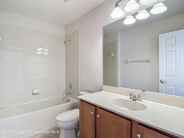 14137 Wake Robin Dr, Brooksville, FL 34604 - bathroom with toilet, vanity, shower / washtub combination, and tile patterned floors