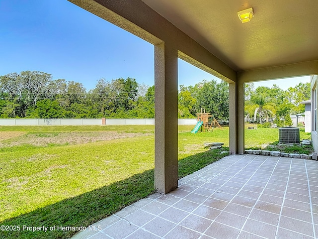 14137 Wake Robin Dr, Brooksville, FL 34604 - view of patio / terrace with central air condition unit, a playground, and view of wooded area