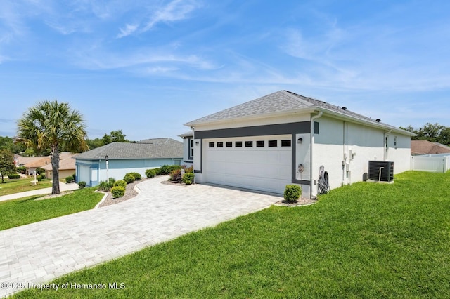 224 W Rexford Dr, Beverly Hills, FL 34465 - view of property exterior featuring central AC, a garage, decorative driveway, and stucco siding