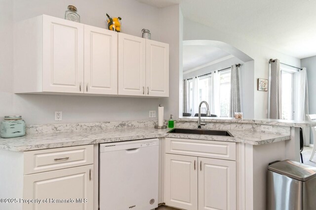 224 W Rexford Dr, Beverly Hills, FL 34465 - kitchen featuring dishwasher, a sink, arched walkways, white cabinetry, and light countertops