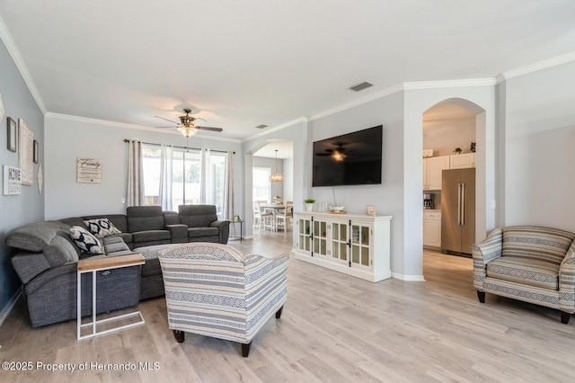 224 W Rexford Dr, Beverly Hills, FL 34465 - living area featuring arched walkways, ornamental molding, light wood-style flooring, ceiling fan, and baseboards