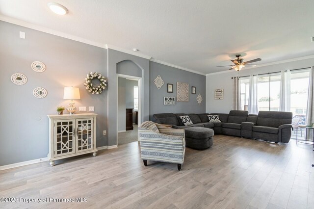 224 W Rexford Dr, Beverly Hills, FL 34465 - living area featuring arched walkways, wood finished floors, a ceiling fan, ornamental molding, and baseboards