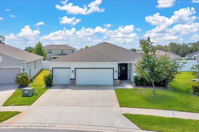13454 Golden Lime Ave, Spring Hill, FL 34609 - view of front of property with a garage, a front lawn, concrete driveway, and roof with shingles