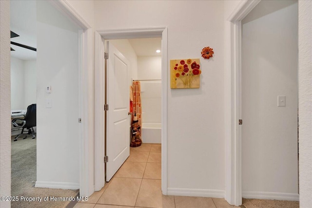 13454 Golden Lime Ave, Spring Hill, FL 34609 - hall featuring a desk, light tile patterned floors, and baseboards