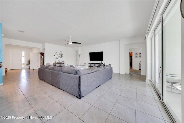 13454 Golden Lime Ave, Spring Hill, FL 34609 - living room featuring light tile patterned floors and a ceiling fan