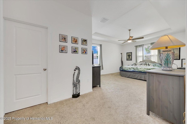 13454 Golden Lime Ave, Spring Hill, FL 34609 - bedroom with a raised ceiling, light colored carpet, baseboards, and a ceiling fan