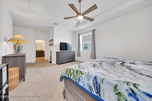 13454 Golden Lime Ave, Spring Hill, FL 34609 - bedroom featuring light colored carpet, ceiling fan, and connected bathroom