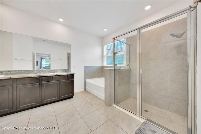 13454 Golden Lime Ave, Spring Hill, FL 34609 - full bath featuring a garden tub, vanity, a shower stall, tile patterned floors, and recessed lighting