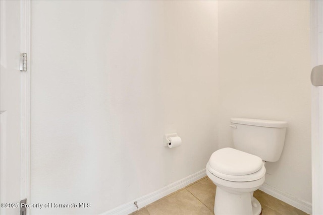 13454 Golden Lime Ave, Spring Hill, FL 34609 - bathroom with toilet, tile patterned flooring, and baseboards