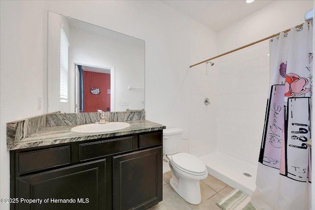 13454 Golden Lime Ave, Spring Hill, FL 34609 - bathroom with toilet, vanity, a tile shower, and tile patterned flooring