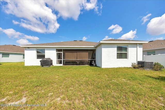 13454 Golden Lime Ave, Spring Hill, FL 34609 - back of property featuring central AC unit, a sunroom, and stucco siding