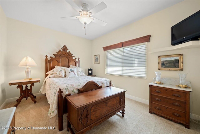 9161 Southern Comfort Ct, Weeki Wachee, FL 34613 - bedroom with light colored carpet, baseboards, and a ceiling fan