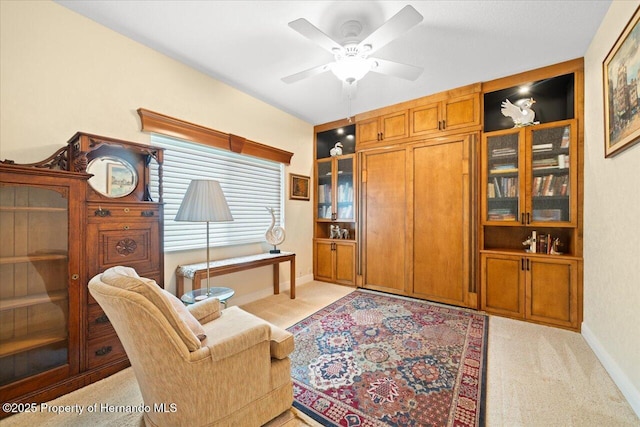 9161 Southern Comfort Ct, Weeki Wachee, FL 34613 - home office with light colored carpet, a ceiling fan, and baseboards