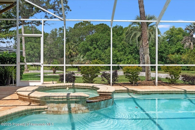 9161 Southern Comfort Ct, Weeki Wachee, FL 34613 - view of swimming pool featuring glass enclosure and a pool with connected hot tub