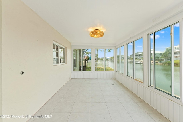 3226 Gardenia Dr, Hernando Beach, FL 34607 - unfurnished sunroom with a water view and tile patterned floors