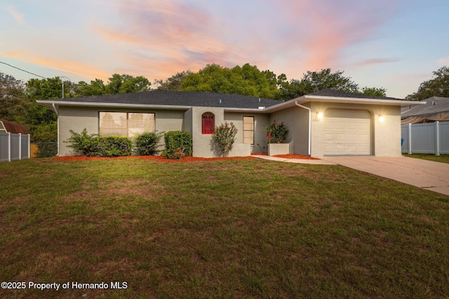 3427 Charmwood Ave, Spring Hill, FL 34609 - view of front of home with driveway, a garage, and stucco siding