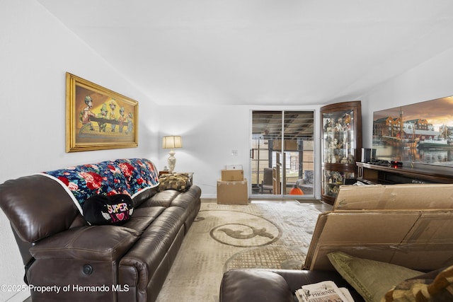 16040 Platinum Dr, Spring Hill Pasco, FL 34610 - living room featuring vaulted ceiling and baseboards