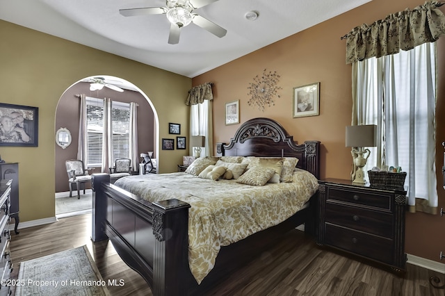 1086 Hook Dr, Spring Hill, FL 34608 - bedroom with arched walkways, dark wood-type flooring, baseboards, and a ceiling fan