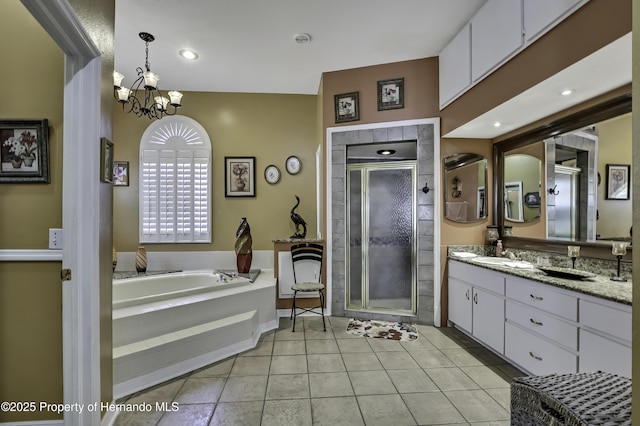 1086 Hook Dr, Spring Hill, FL 34608 - full bathroom featuring vanity, a bath, a shower stall, a chandelier, and tile patterned flooring
