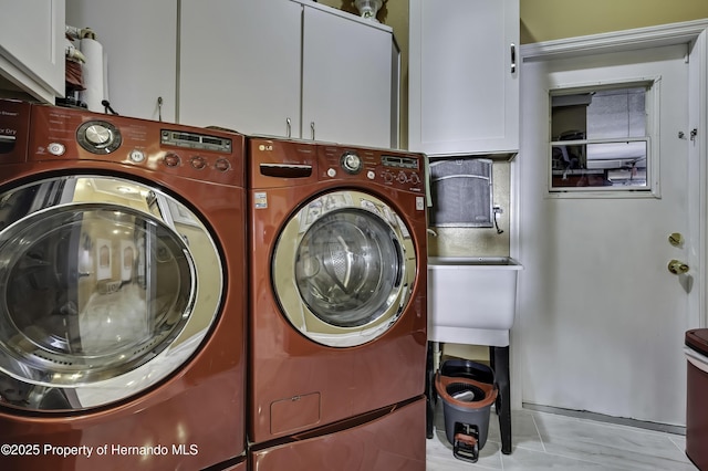 1086 Hook Dr, Spring Hill, FL 34608 - washroom with washer and dryer and cabinet space