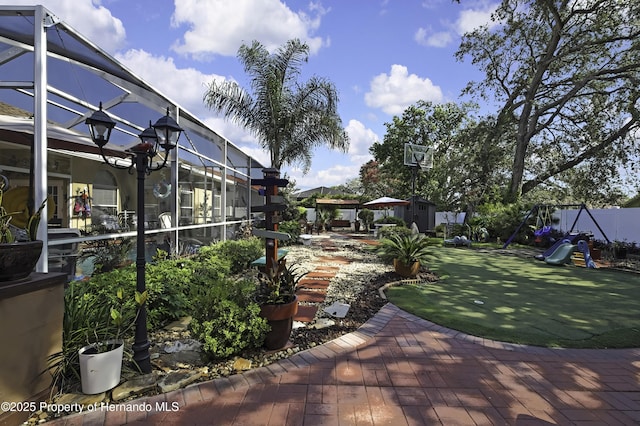 1086 Hook Dr, Spring Hill, FL 34608 - view of grassy yard with a playground, a patio, and a lanai