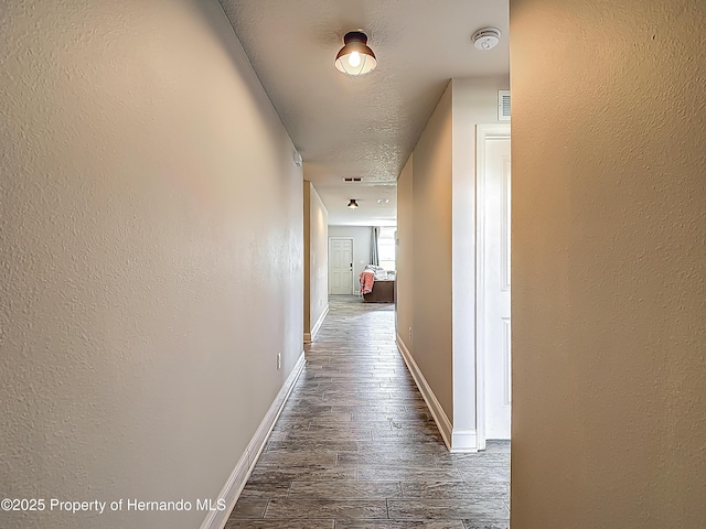 277 Hampshire Ave, Spring Hill, FL 34606 - corridor with dark wood-type flooring, baseboards, and a textured wall