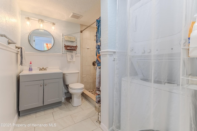 5507 Darlene St, Weeki Wachee, FL 34607 - bathroom with a stall shower, vanity, toilet, tile patterned floors, and a wainscoted wall